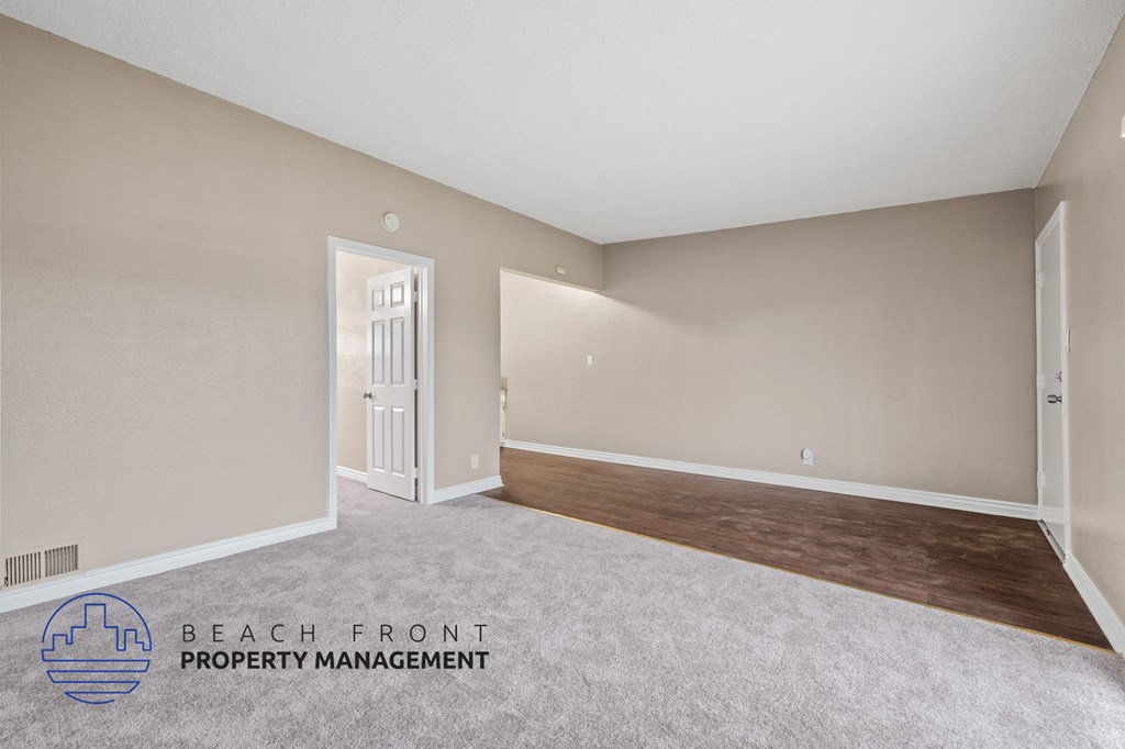 the living room and dining room of an apartment