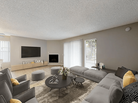 A modern living room with grey couches and a coffee table.