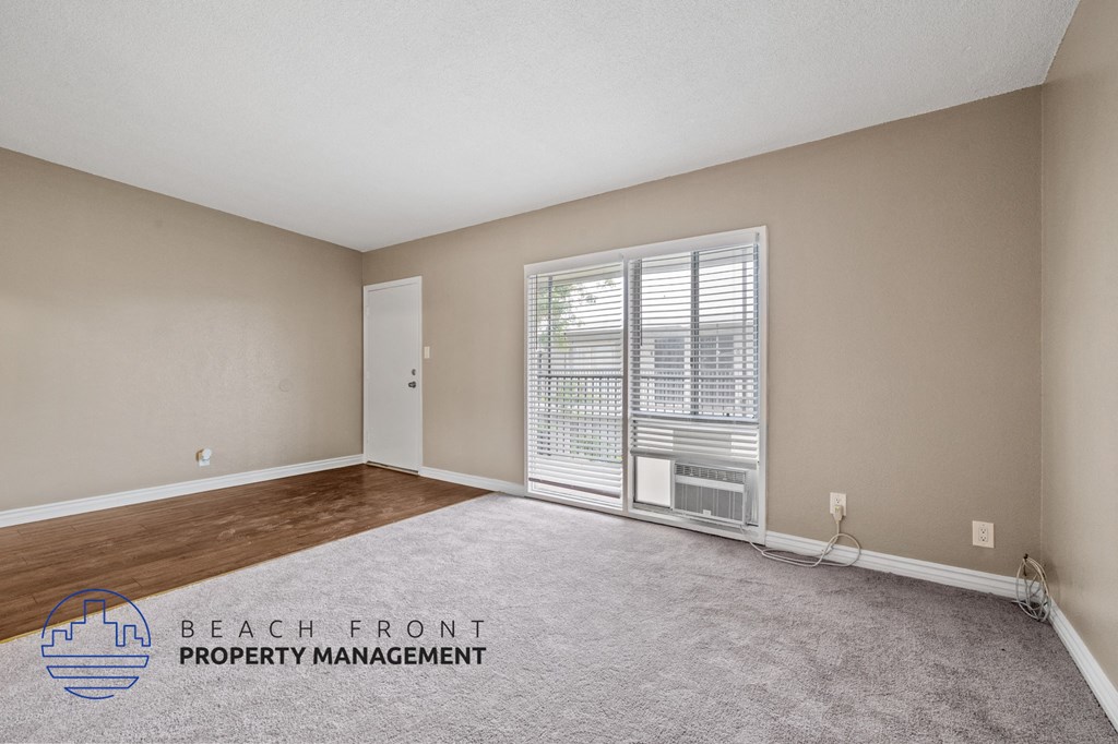 the living room of an apartment with a large window