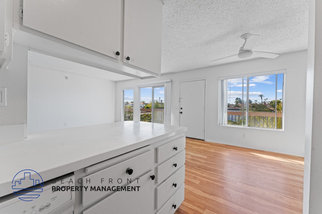 A well-lit, empty room with a view of the outdoors through a window.
