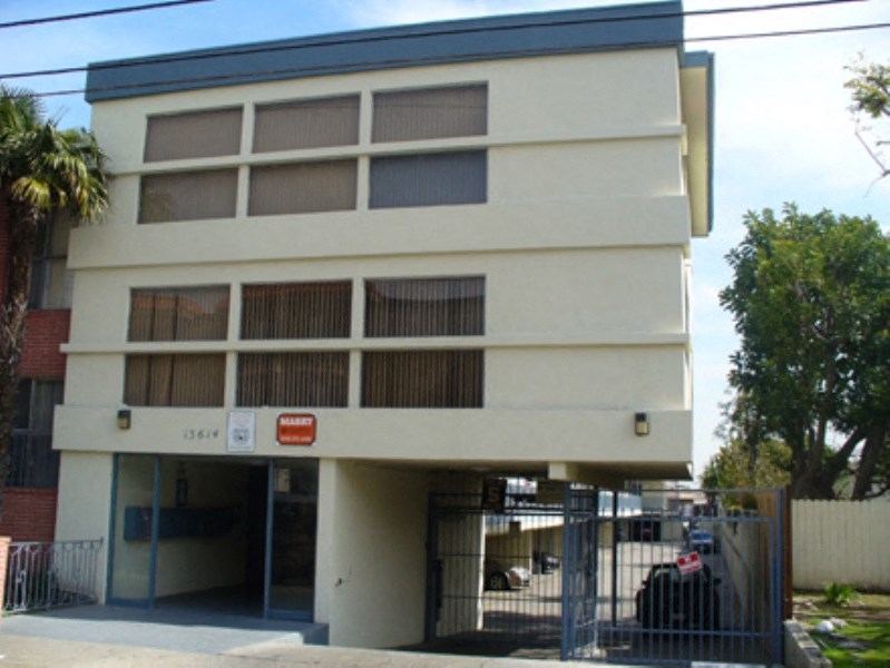 a building with a fence and a gate in front of it