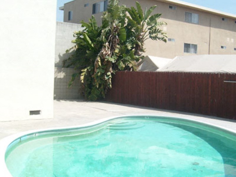 a swimming pool in the backyard of a house