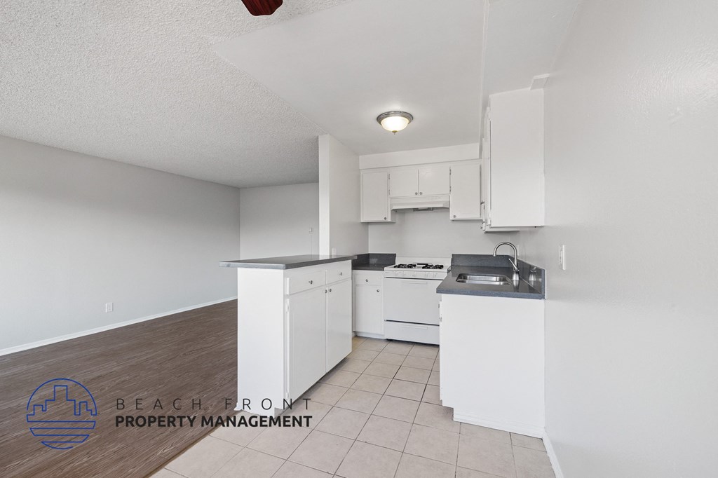 a white kitchen with white cabinets and white appliances