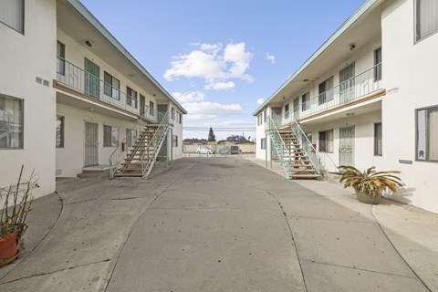 A courtyard between two buildings with staircases on either side.