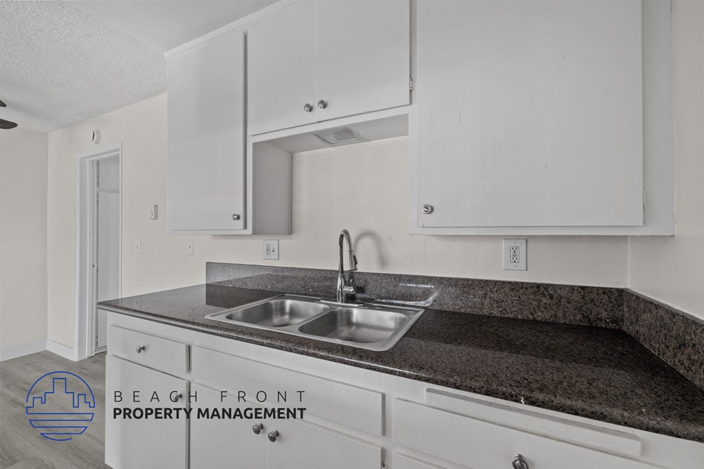 A kitchen with a sink and cabinets.
