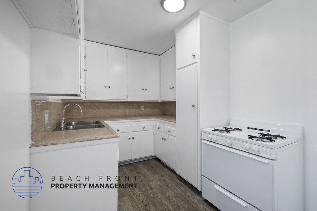 a white kitchen with white appliances and white cabinets