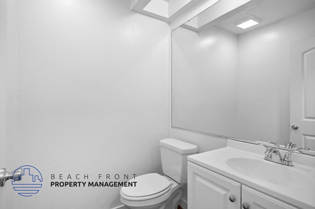 a bathroom with a toilet and a sink and a mirror