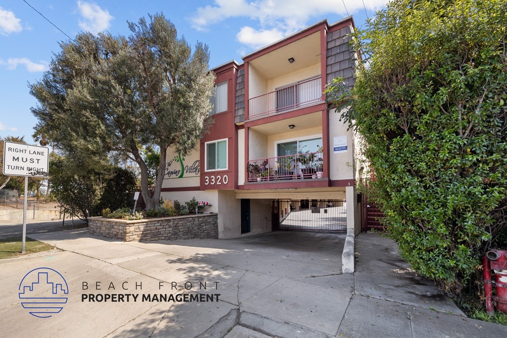 A two-story building with a balcony and a sign that says "FIGHT LANE MUST TURN".