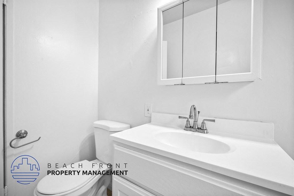 a bathroom with a sink and a toilet and a mirror