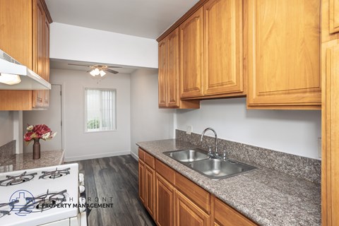 A kitchen with wooden cabinets and a stove top.