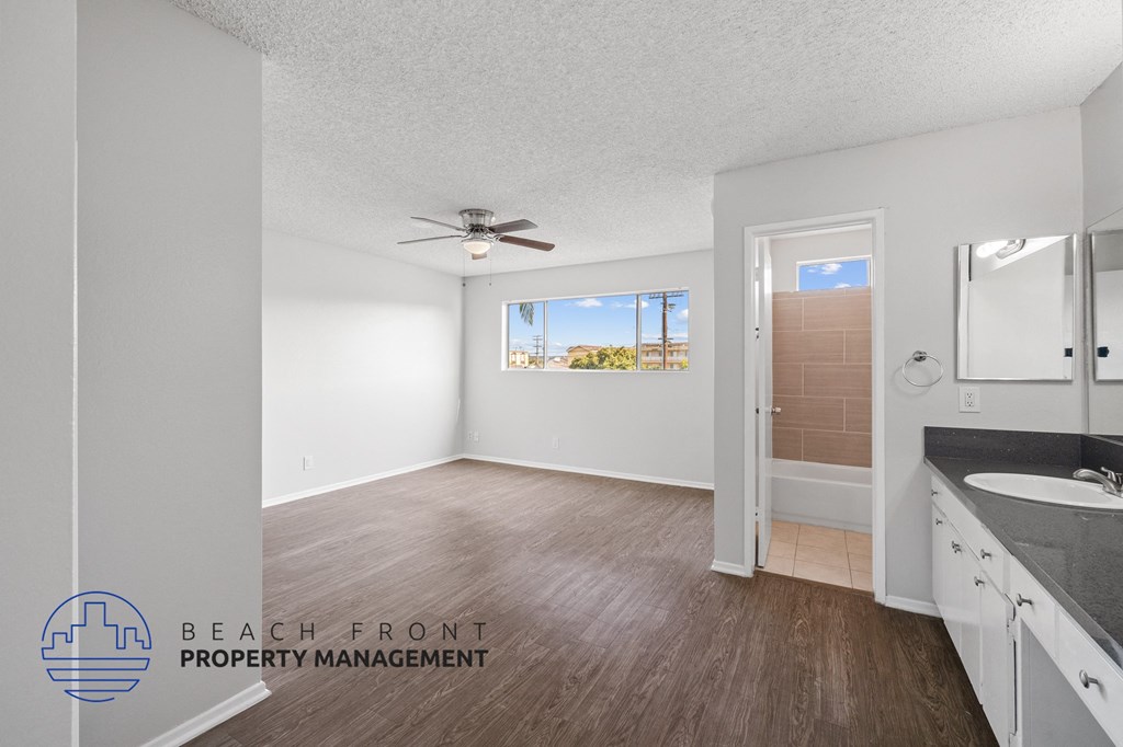 the master bathroom of this new construction home has a large vanity and a large window