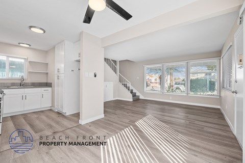 A spacious living room with a staircase leading to the upper floor.