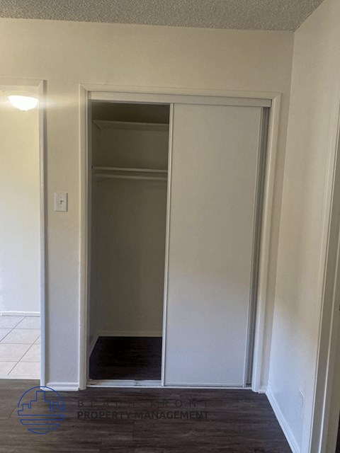 an open closet door with a black rug on the floor