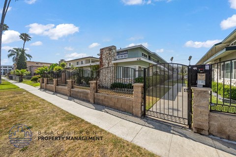 a gate with a fence in front of a building