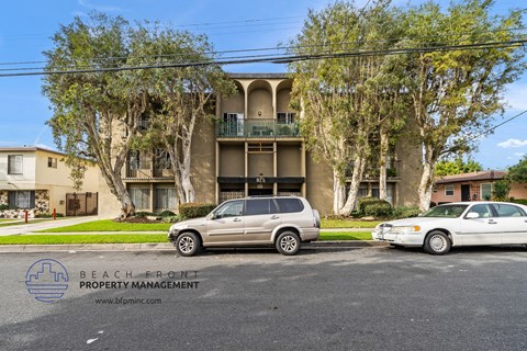 two cars parked in front of an apartment building