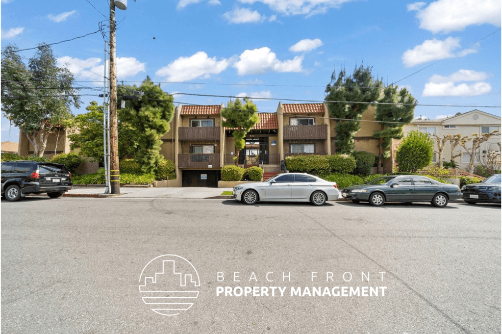 a city street with cars parked in front of apartment buildings