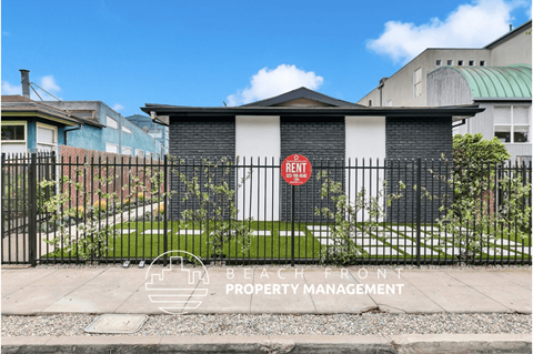 a gate with a red sign on it in front of a house