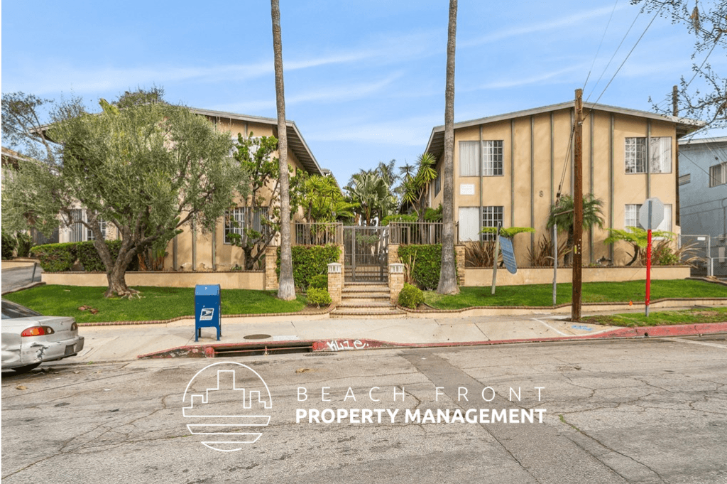 an image of a beachfront property with a blue sign in the street