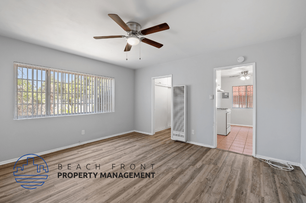 a living room with wood flooring and a ceiling fan