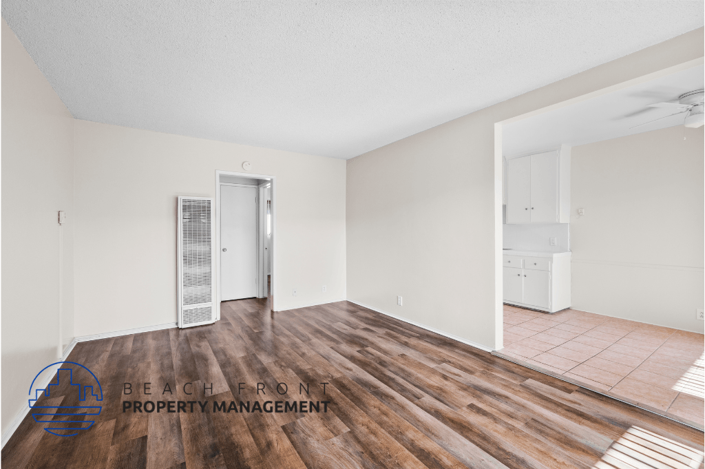 a renovated living room with wood floors and white walls