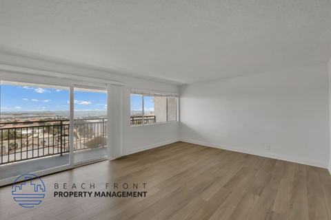 an open living room with a balcony overlooking the city