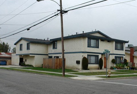 a white house on the corner of a street