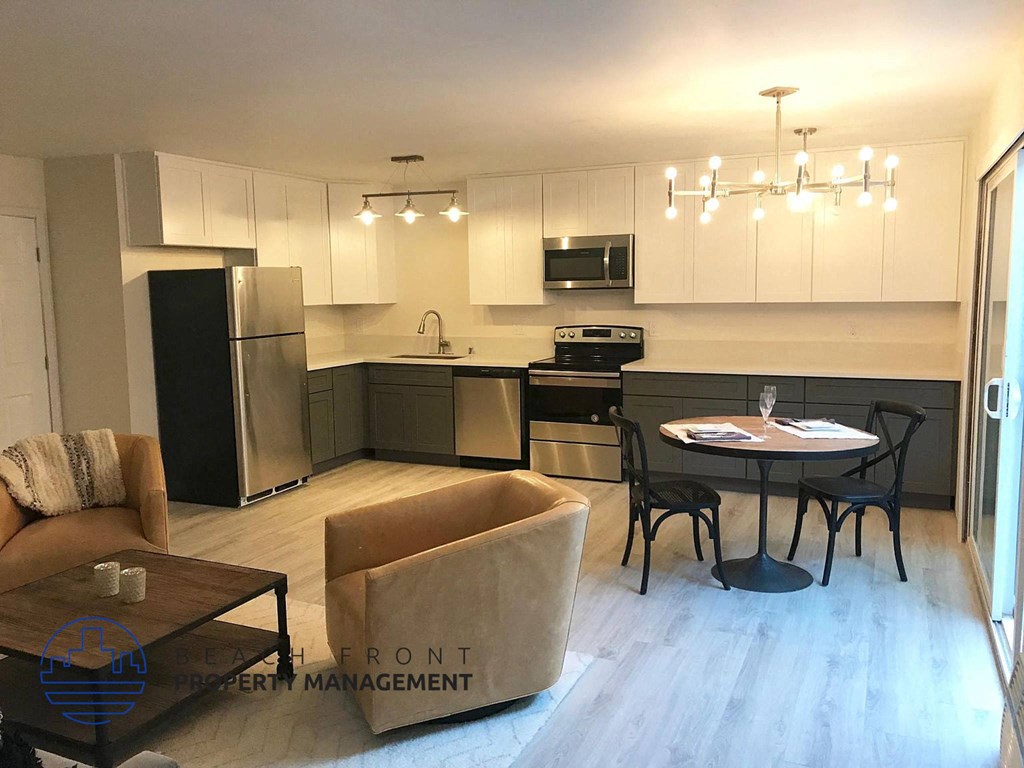 A well-lit kitchen with a dining table set for two.