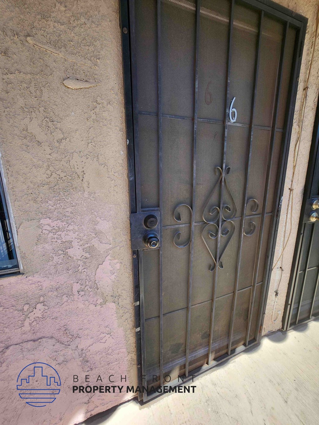 A metal gate with the number 6 on it is closed.