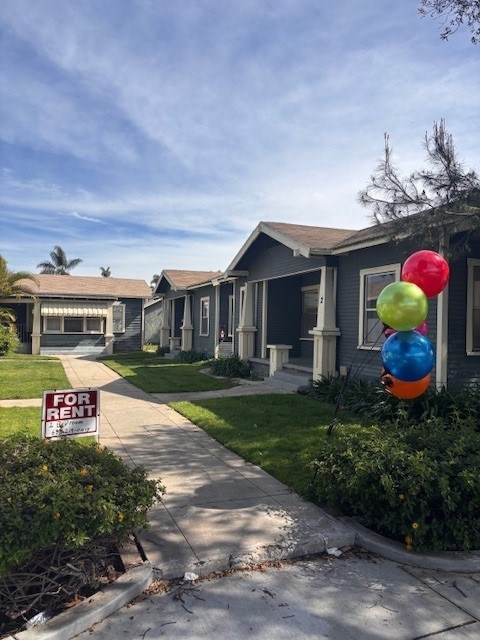 A house is for rent with a sign in front of it.