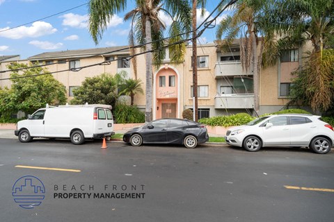 three cars parked in front of an apartment building