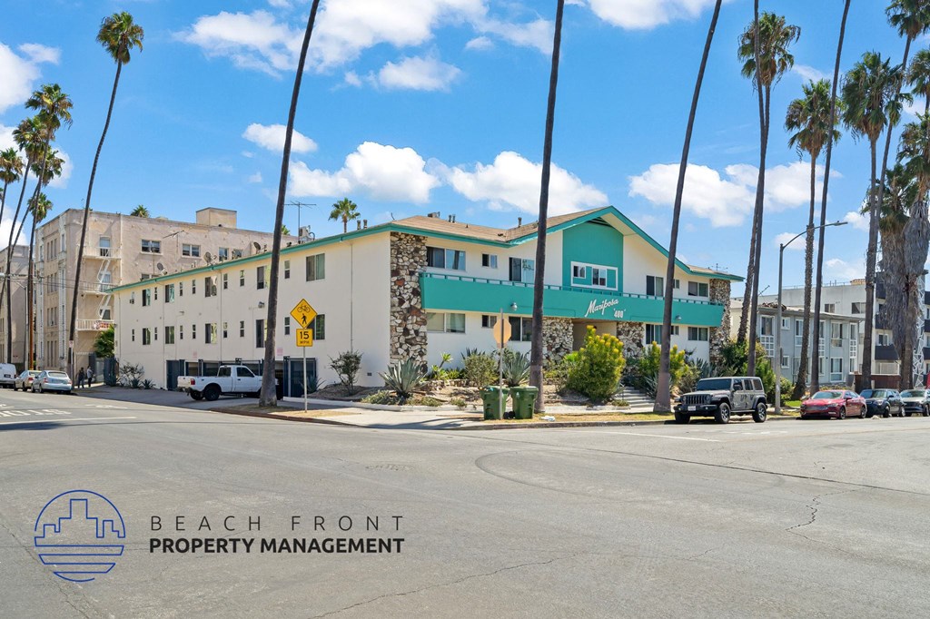A street view of a building with the logo of Beach Front Property Management on the bottom left.