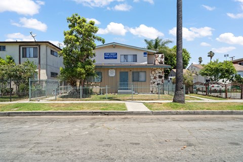 A building with a blue sign in front of it.