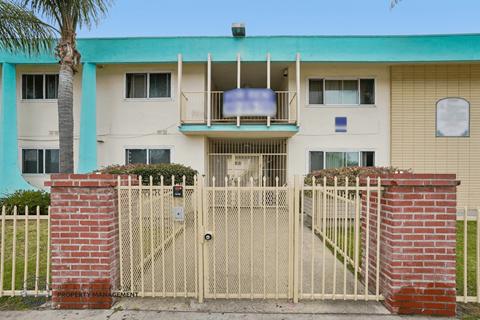 A building with a gate and a sign that says