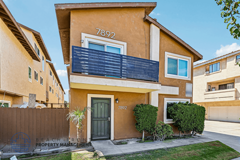 A two-story house with the number 7892 on the front.