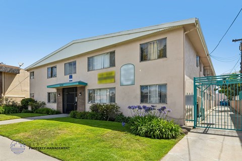 A building with a green gate in front of it.