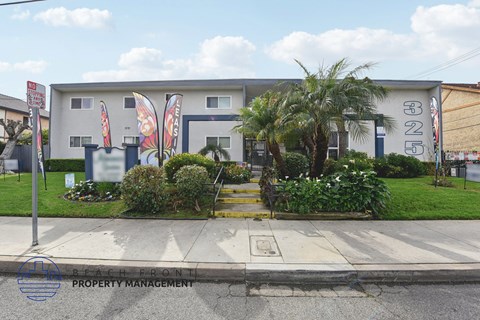 A white building with a butterfly sign on the front.