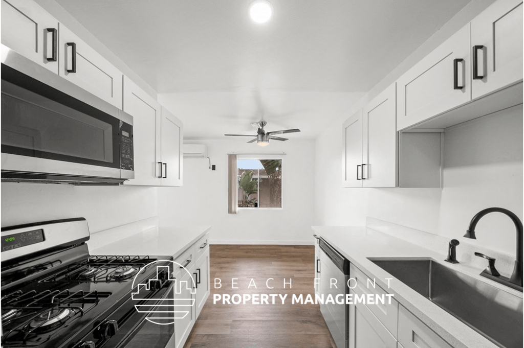 a kitchen with white cabinets and a stove and a microwave