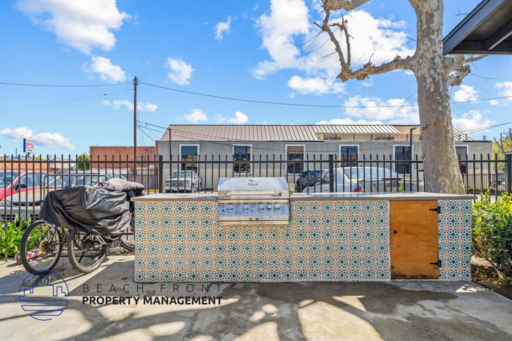 a barbecue grill with a bike parked in front of a building