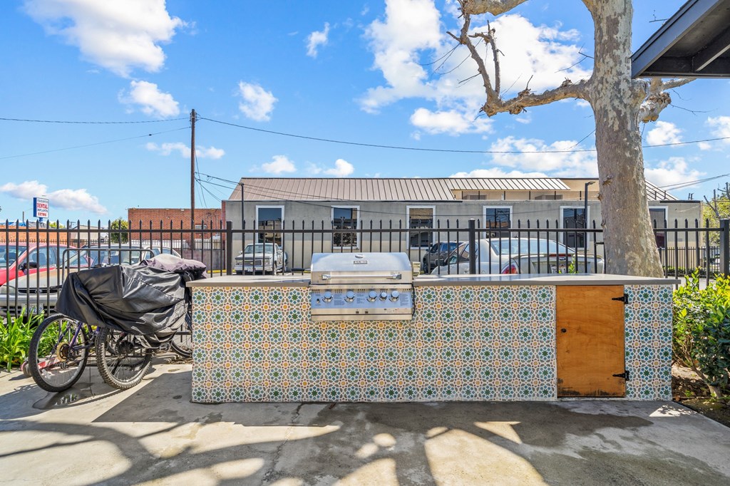 a barbecue grill with a bike parked in front of a building