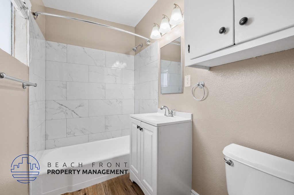 a bathroom with a sink and a toilet and a shower