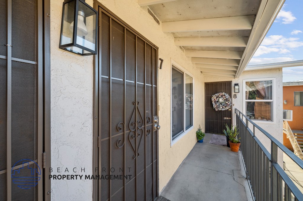A balcony with a door and a window.