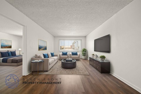A living room with a flat screen TV mounted on the wall.