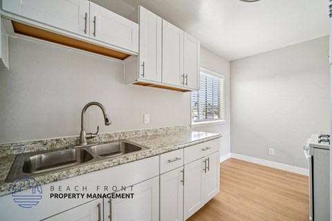 A kitchen with a sink and cabinets.