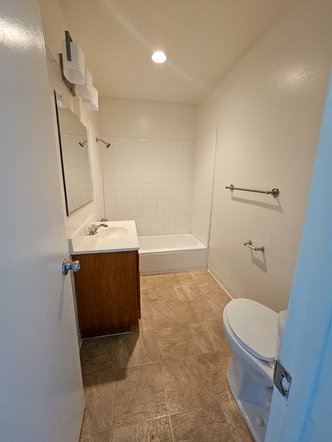 a bathroom with a sink toilet and a bath tub