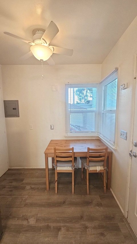 A dining room with a table and chairs.