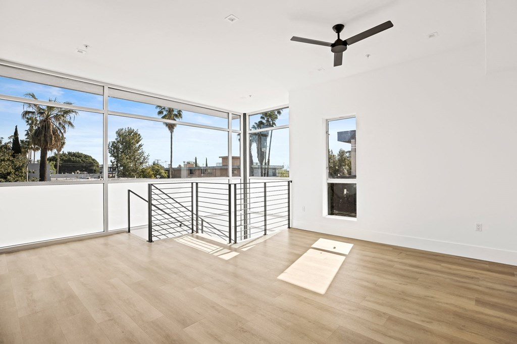 a living room with a balcony and a yoga mat on the floor