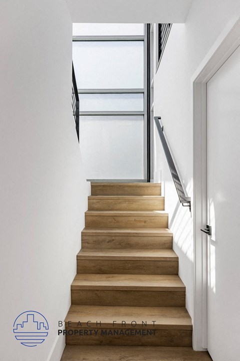 a flight of stairs with a glass door at the top