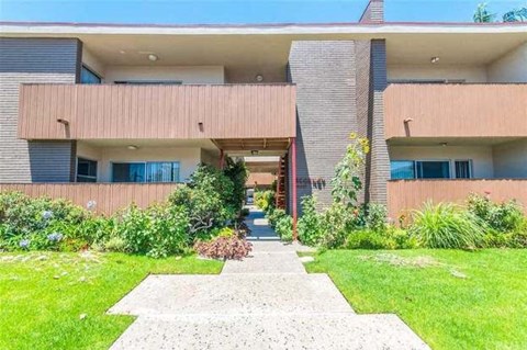 a large building with a sidewalk in front of it