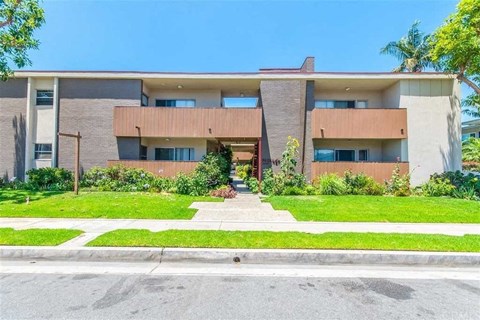 a house with a sidewalk and grass in front of it