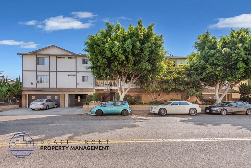 a street view of a building with cars parked in front